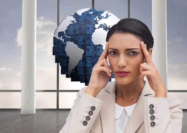 Businesswoman putting her fingers on her temples — Stock Photo, Image