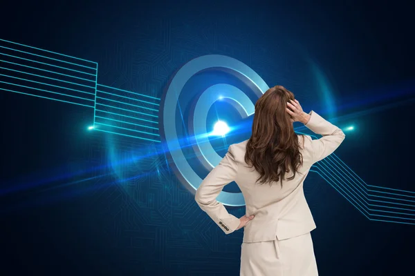 Composite image of businesswoman standing back to camera with hand on head — Stock Photo, Image