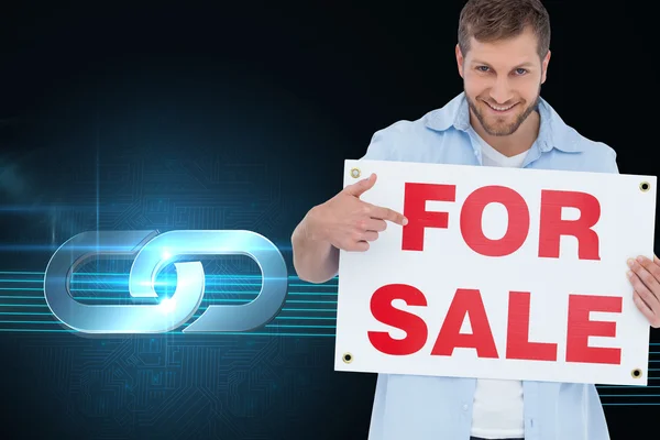 Model holding a for sale sign — Stock Photo, Image