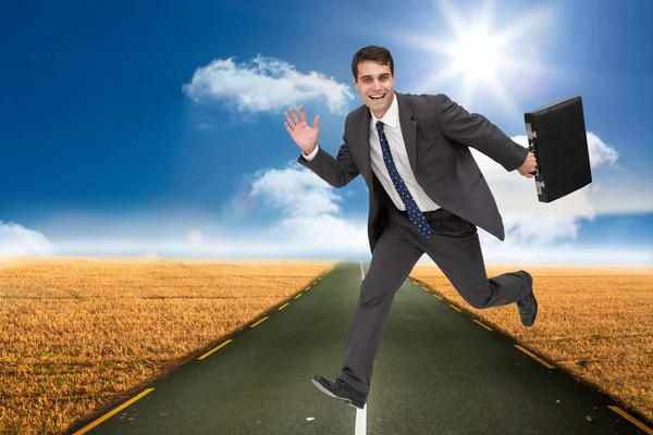 Sonriendo atractivo hombre de negocios en un hury — Foto de Stock