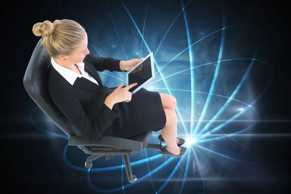 Businesswoman sitting on swivel chair with tablet — Stock Photo, Image