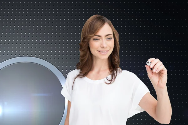 Composite image of smiling businesswoman holding marker — Stock Photo, Image