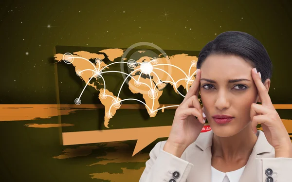Businesswoman putting her fingers on her temples — Stock Photo, Image