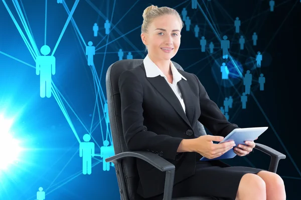 Composite image of businesswoman sitting on swivel chair with tablet — Stock Photo, Image