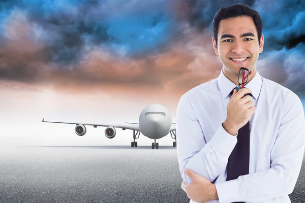 Composite image of smiling businessman holding glasses — Stock Photo, Image