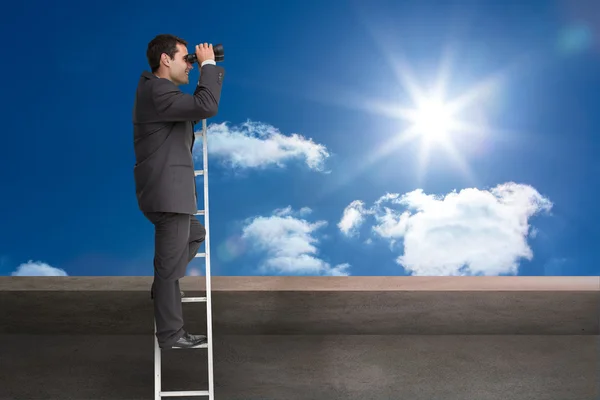 Composite image of businessman standing on ladder — Stock Photo, Image