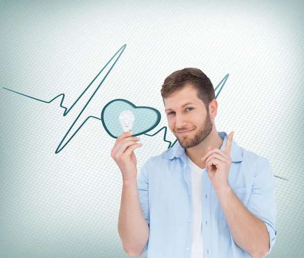 Charming model holding a bulb in right hand — Stock Photo, Image