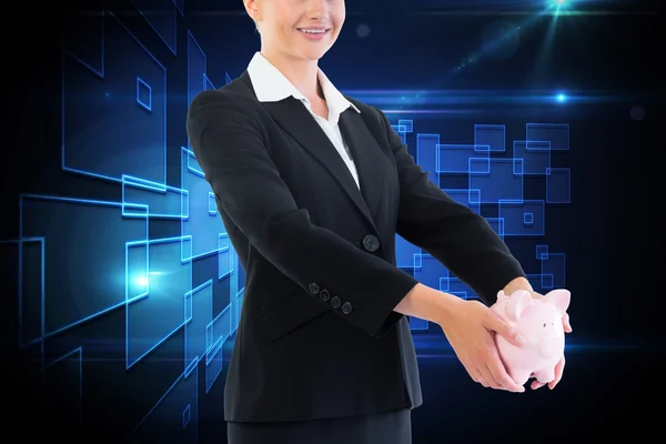 Composite image of businesswoman holding piggy bank — Stock Photo, Image