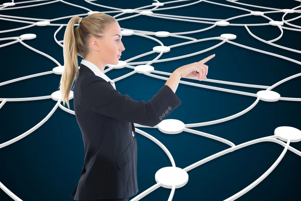 Composite image of businesswoman pointing somewhere — Stock Photo, Image