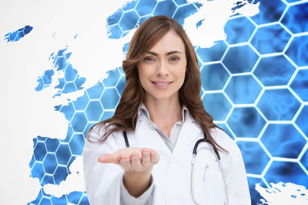 Smiling doctor presenting her hand — Stock Photo, Image