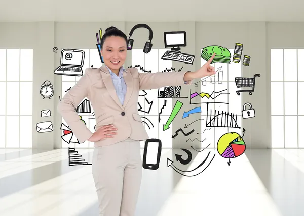 Composite image of smiling asian businesswoman pointing — Stock Photo, Image