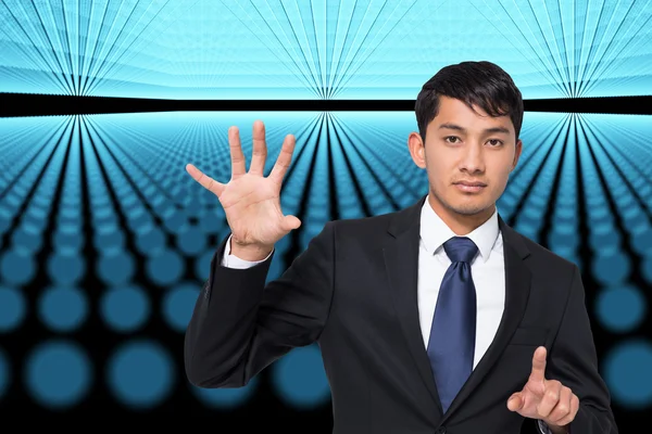 Composite image of unsmiling businessman holding and pointing — Stock Photo, Image