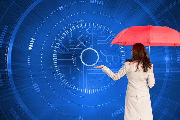 Brunette businesswoman holding umbrella — Stock Photo, Image