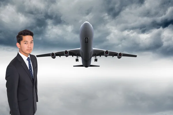 Composite image of unsmiling businessman looking at camera — Stock Photo, Image