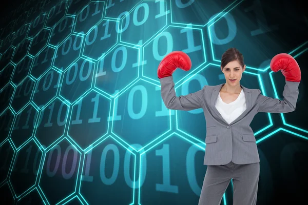 Image composite de femme d'affaires avec gants de boxe — Photo