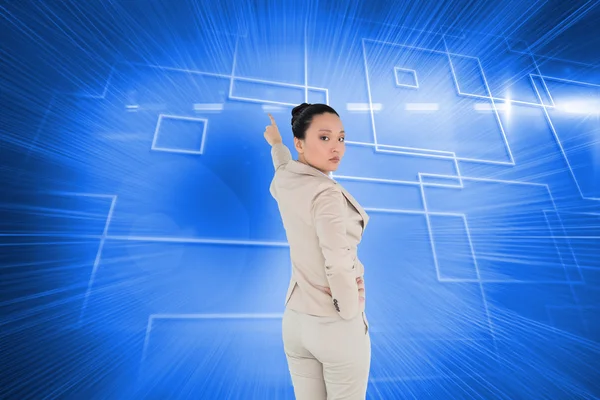 Composite image of unsmiling asian businesswoman pointing — Stock Photo, Image