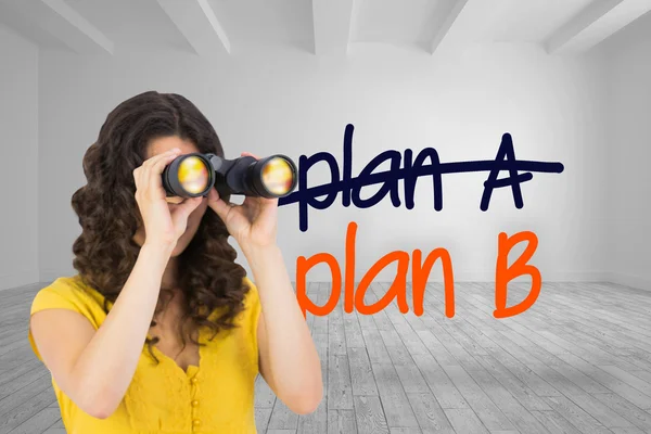 Composite image of casual young woman using binoculars — Stock Photo, Image