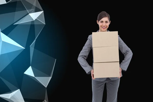 Composite image of smiling businesswoman carrying cardboard boxes — Stock Photo, Image