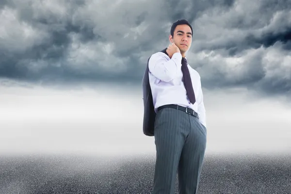 Composite image of unsmiling businessman standing — Stock Photo, Image