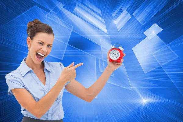 Businesswoman indicating alarm clock with finger — Stock Photo, Image