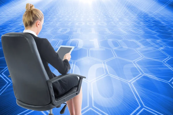 Composite image of businesswoman sitting on swivel chair with tablet — Stock Photo, Image