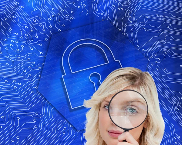 Woman looking through a magnifying glass — Stock Photo, Image