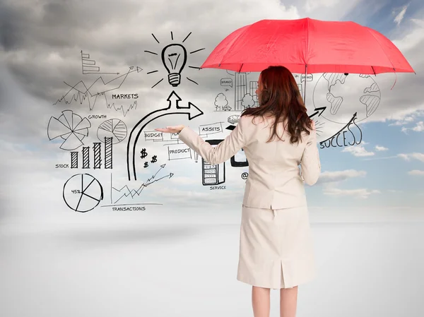 Composite image of businesswoman holding umbrella — Stock Photo, Image