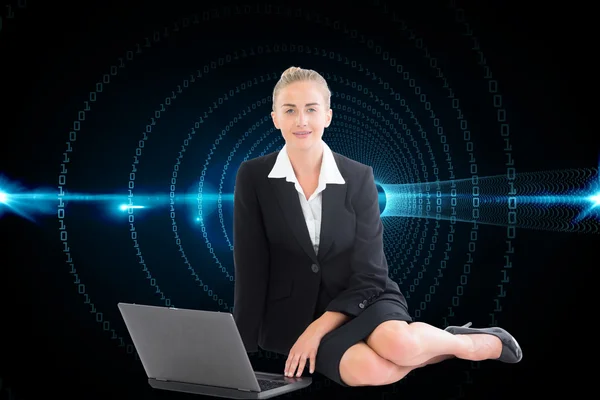 Composite image of businesswoman using laptop — Stock Photo, Image