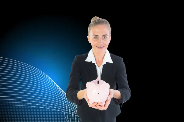 Složený obraz podnikatelka drží růžové prasátko — Stock fotografie