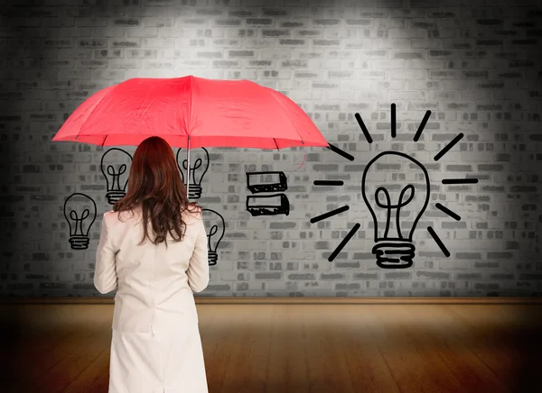 Composite image of businesswoman standing back to camera — Stock Photo, Image