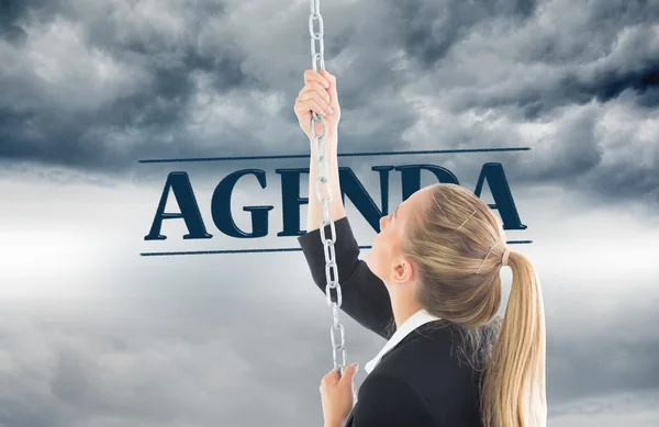 Composite image of businesswoman pulling a chain — Stock Photo, Image