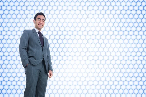 Composite image of smiling businessman standing — Stock Photo, Image