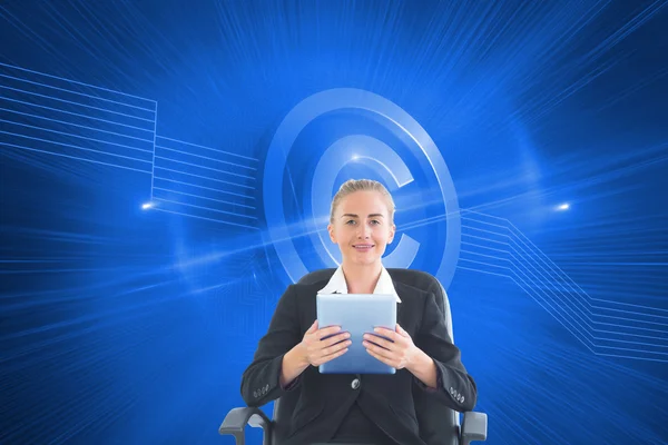 Composite image of businesswoman sitting on swivel chair with tablet — Stock Photo, Image