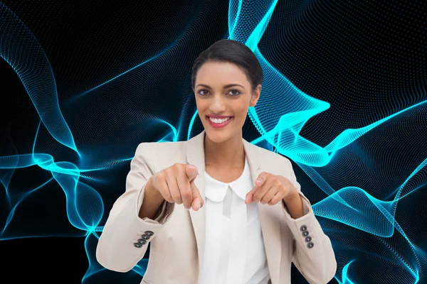 Composite image of smiling businesswoman pointing at the camera — Stock Photo, Image