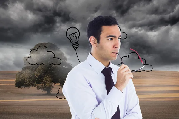 Composite image of unsmiling businessman holding glasses — Stock Photo, Image