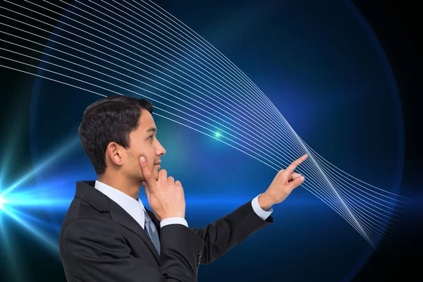 Composite image of thoughtful asian businessman pointing — Stock Photo, Image