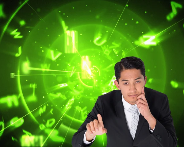 Composite image of thoughtful asian businessman pointing — Stock Photo, Image