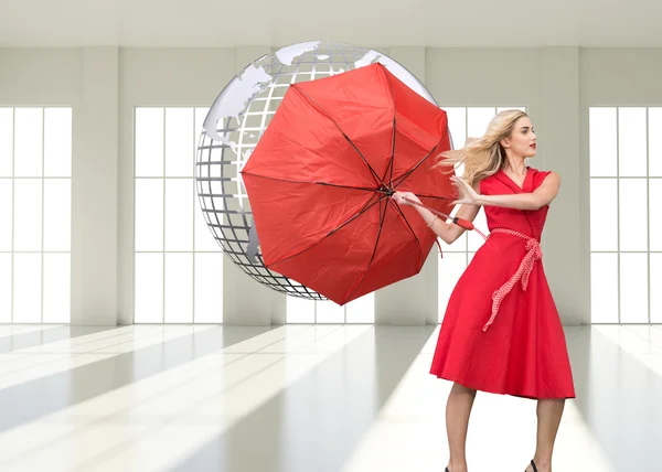 Composite image of elegant blonde holding umbrella — Stock Photo, Image