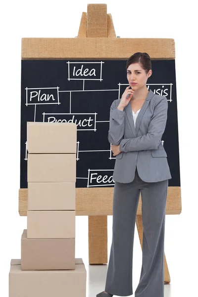 Businesswoman posing with cardboard boxes — Stock Photo, Image