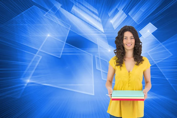 Smiling curly haired brunette holding notebooks — Stock Photo, Image