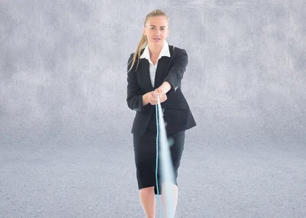 Composite image of businesswoman pulling a rope — Stock Photo, Image