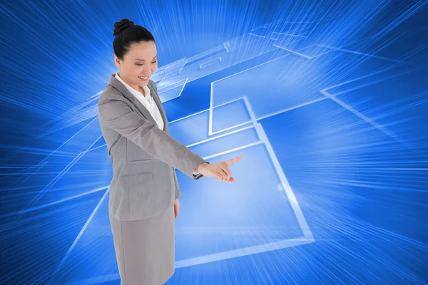 Composite image of smiling asian businesswoman pointing — Stock Photo, Image