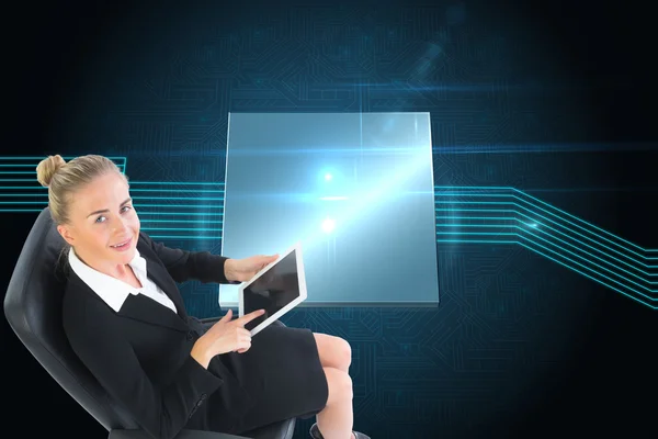 Composite image of businesswoman sitting on swivel chair with tablet — Stock Photo, Image