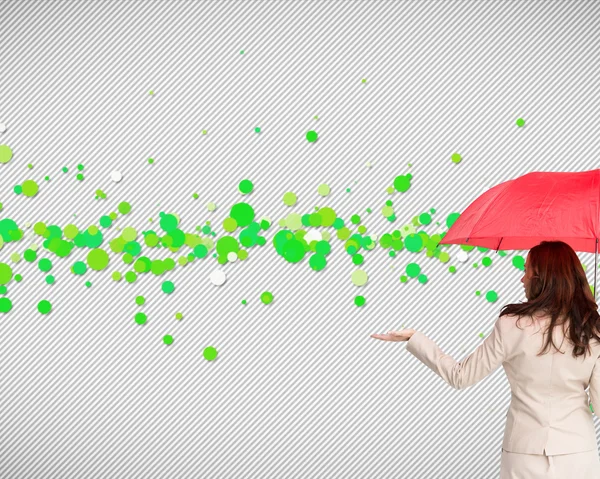 Composite image of businesswoman holding umbrella — Stock Photo, Image