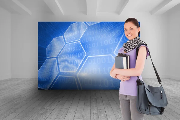 Student holding boeken en haar tas — Stockfoto