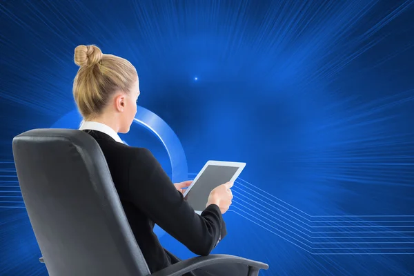 Composite image of businesswoman sitting on swivel chair with tablet — Stock Photo, Image