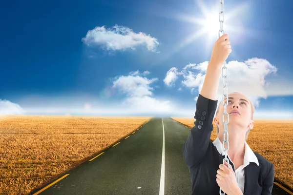 Composite image of businesswoman pulling a chain — Stock Photo, Image