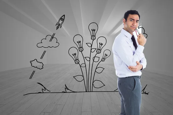 Composite image of thinking businessman holding glasses — Stock Photo, Image