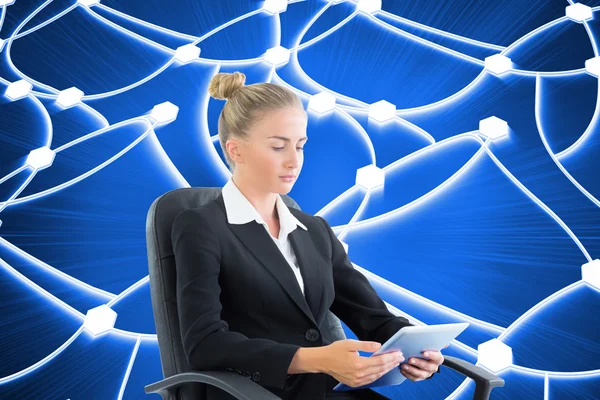 Composite image of businesswoman sitting on swivel chair with ta — Stock Photo, Image