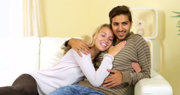 Cute happy couple relaxing together on the couch — Stock Video